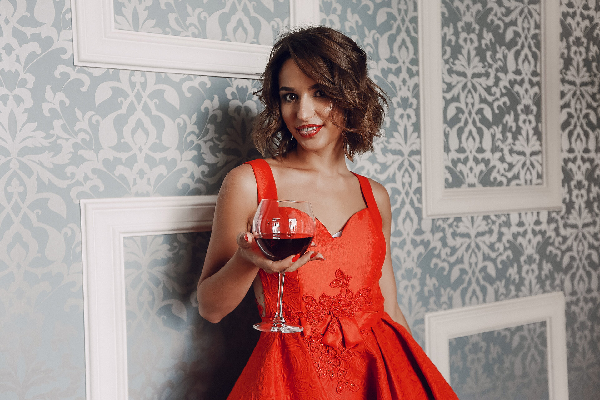 Elegant woman savoring a glass of red wine